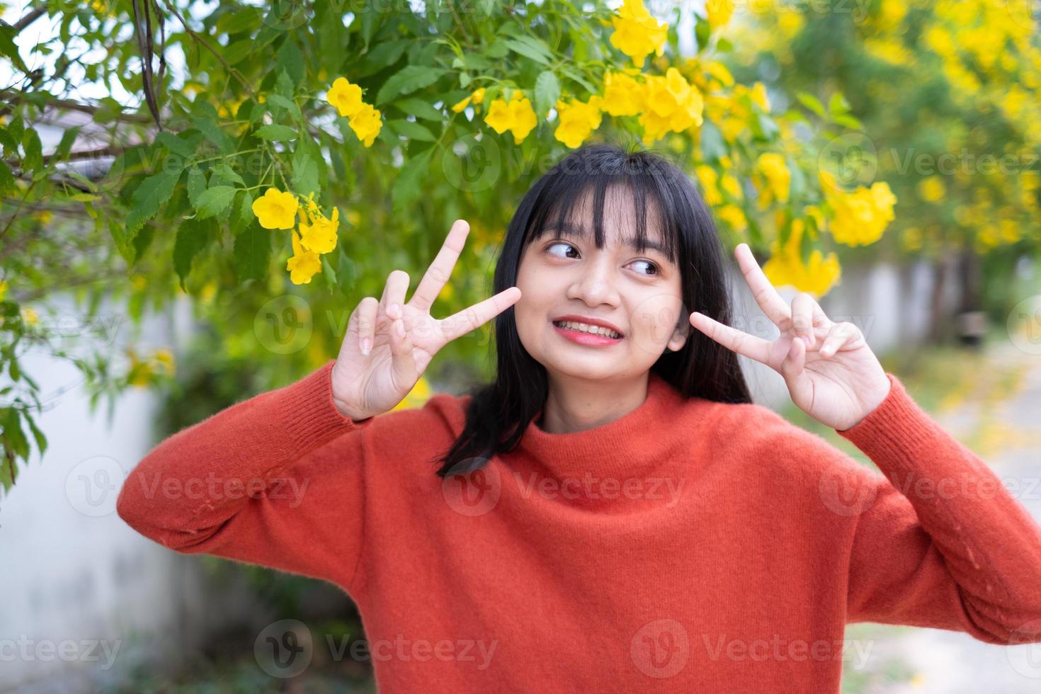 Portrait young girl with yellow flowers, Asian girl. photo