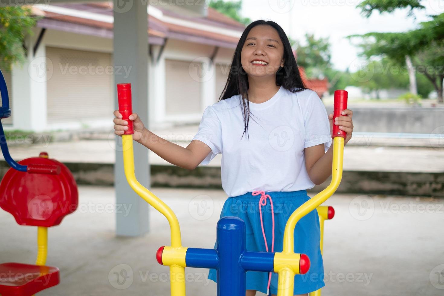 Young girl doing exercise with colorful equipment exercise. photo