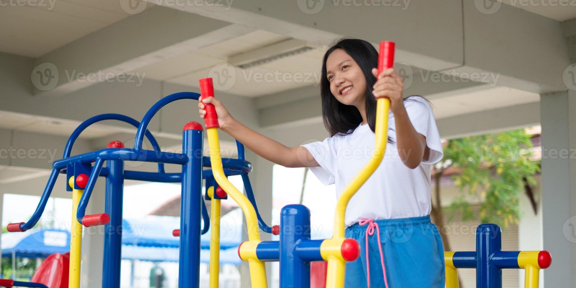 Young girl doing exercise with colorful equipment exercise. photo