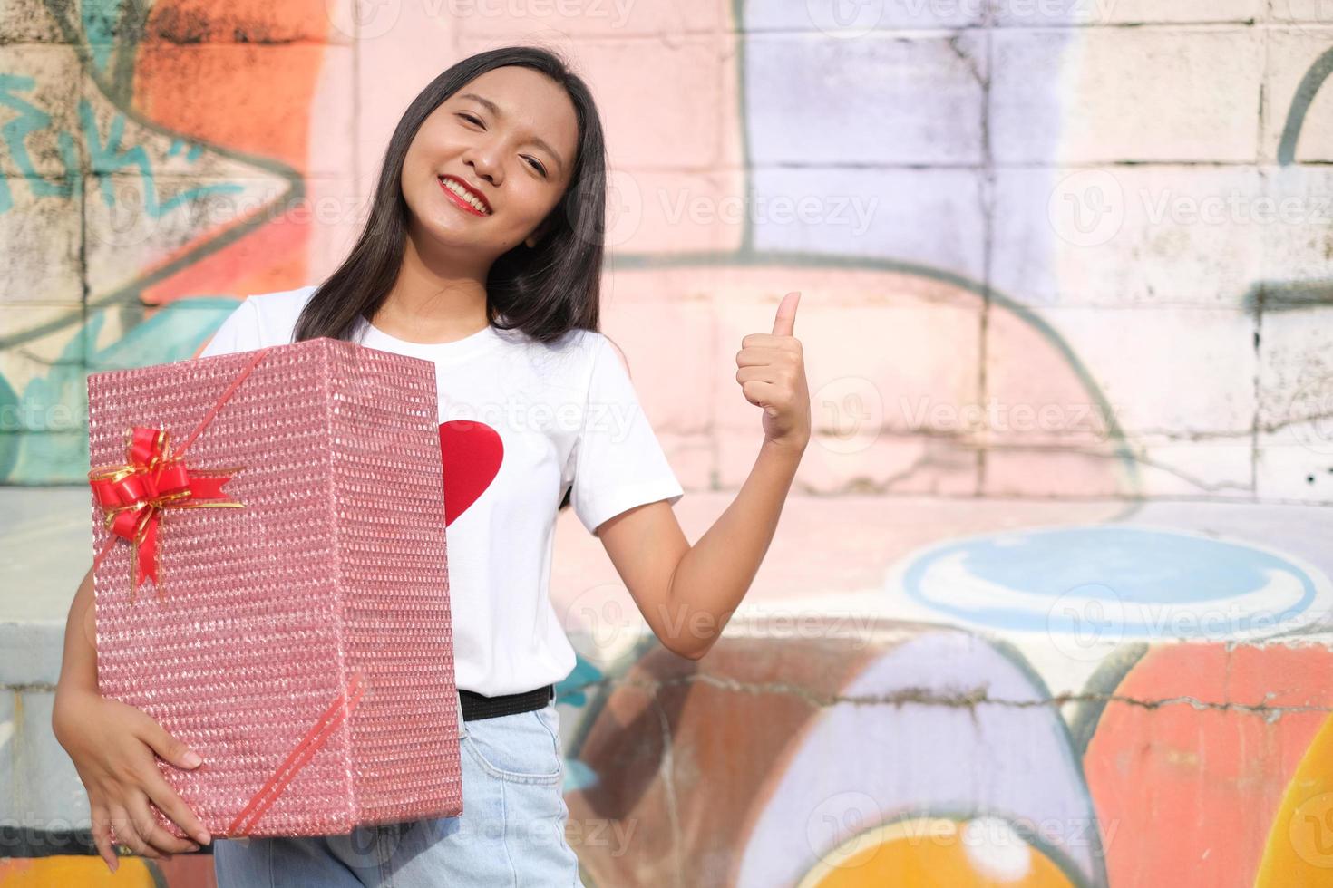 Happy young girl with gift box. photo