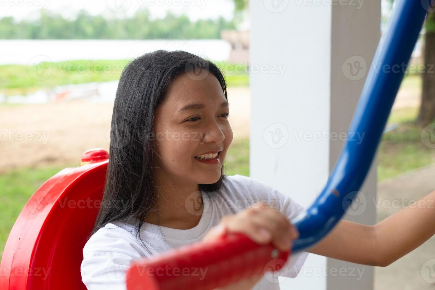 Young girl doing exercise with colorful equipment exercise. photo