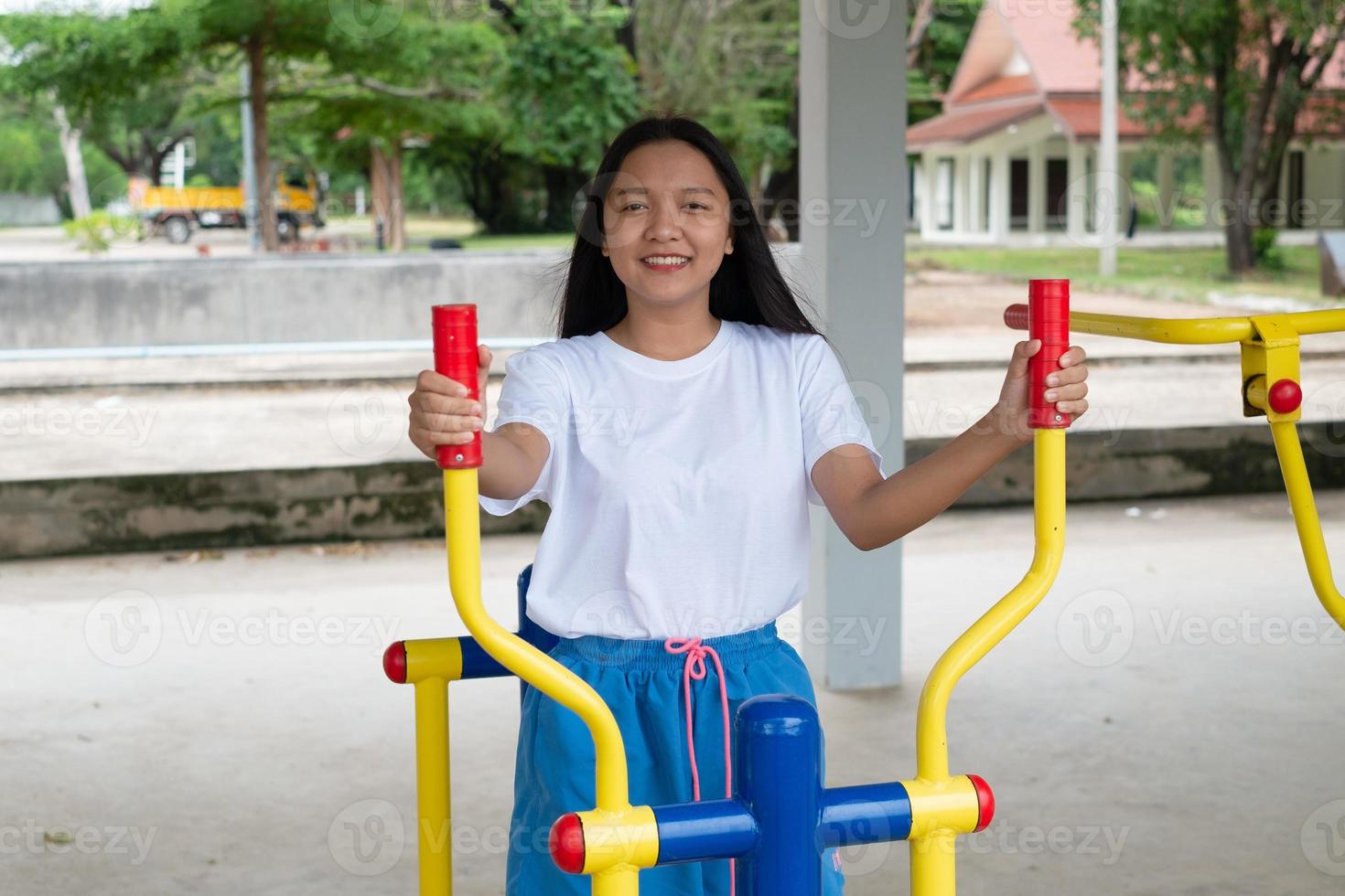 Young girl doing exercise with colorful equipment exercise. photo
