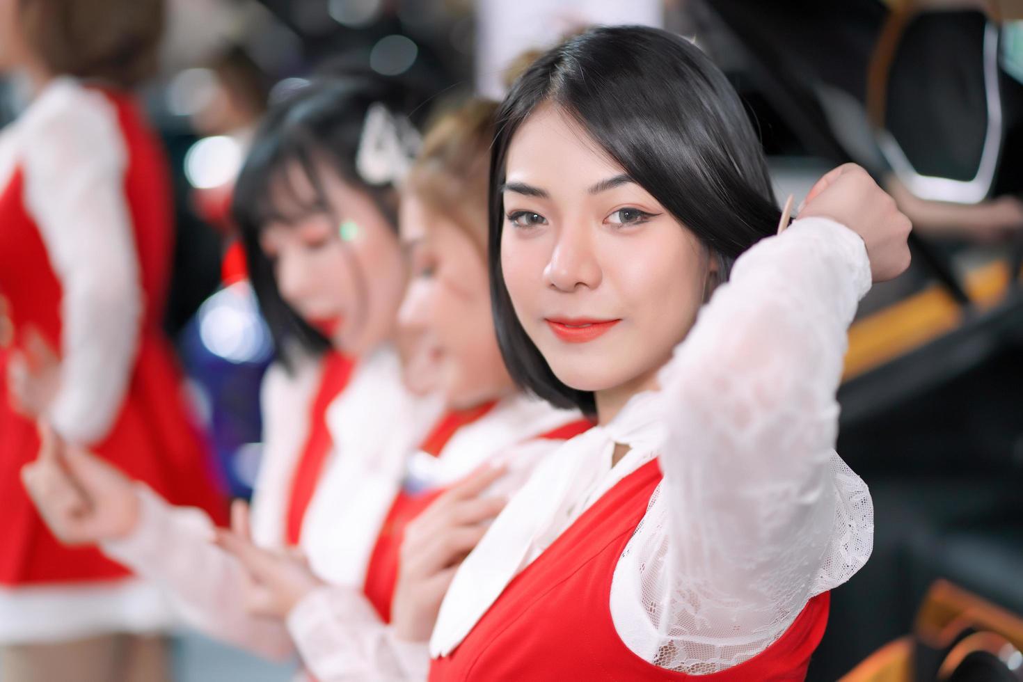 Nonthaburi, Thailand - DEC 3, 2019 Unidentified model poses with a car at The 36th Motor Expo Thailand 2019 at IMPACT Arena, Muang Thong Thani, Nonthaburi, Thailand. photo
