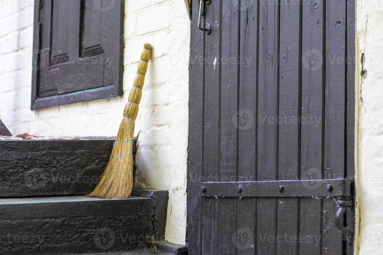 Broom on the threshold of a country house. Broom near the entrance to a house in the countryside. photo