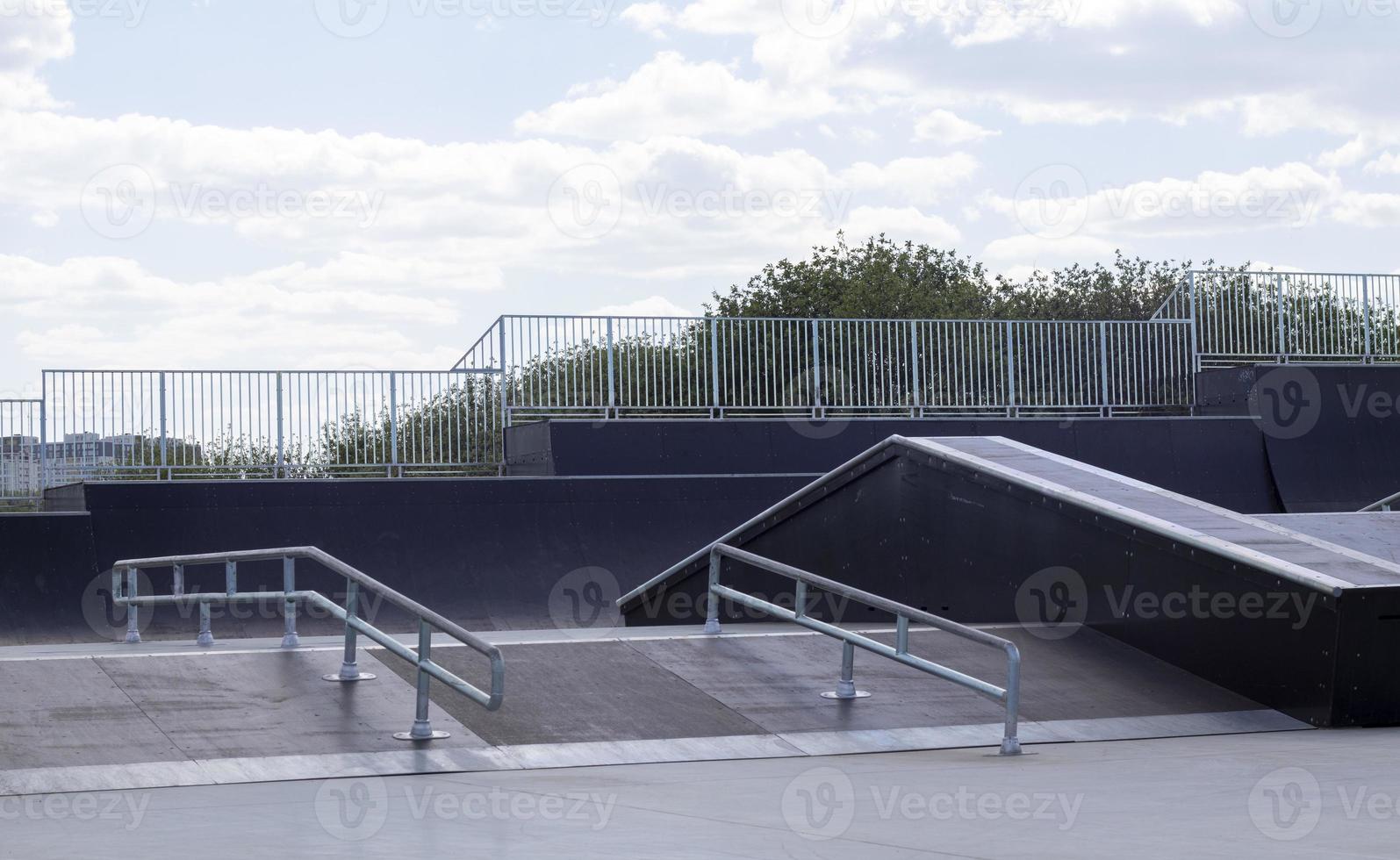 Skate park during the day. Empty, no people skating park. Skatepark ramps. photo