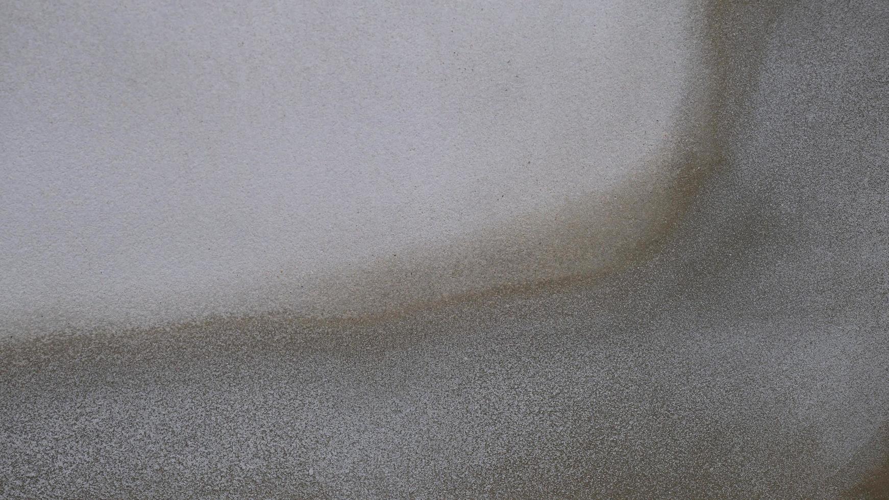 The old cement wall was weathered, the surface was scratched, the surface was scratched and damaged. For a mysterious retro-conservative background. photo