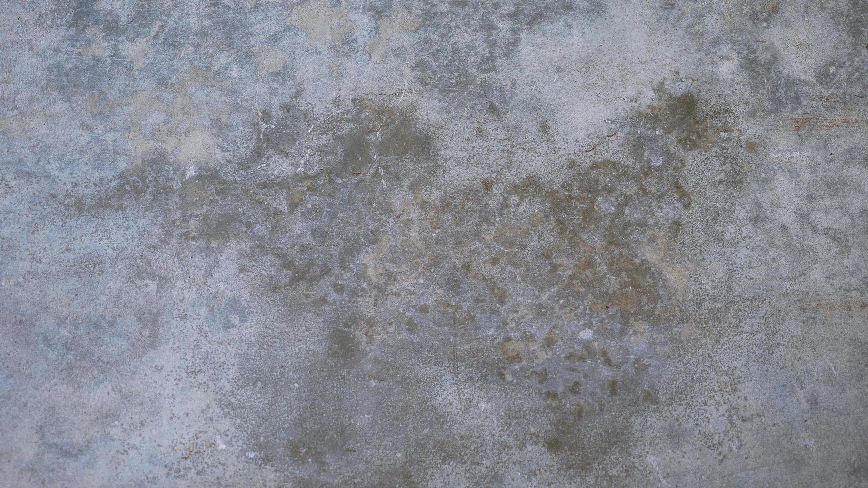 The old cement wall was weathered, the surface was scratched, the surface was scratched and damaged. For a mysterious retro-conservative background. photo