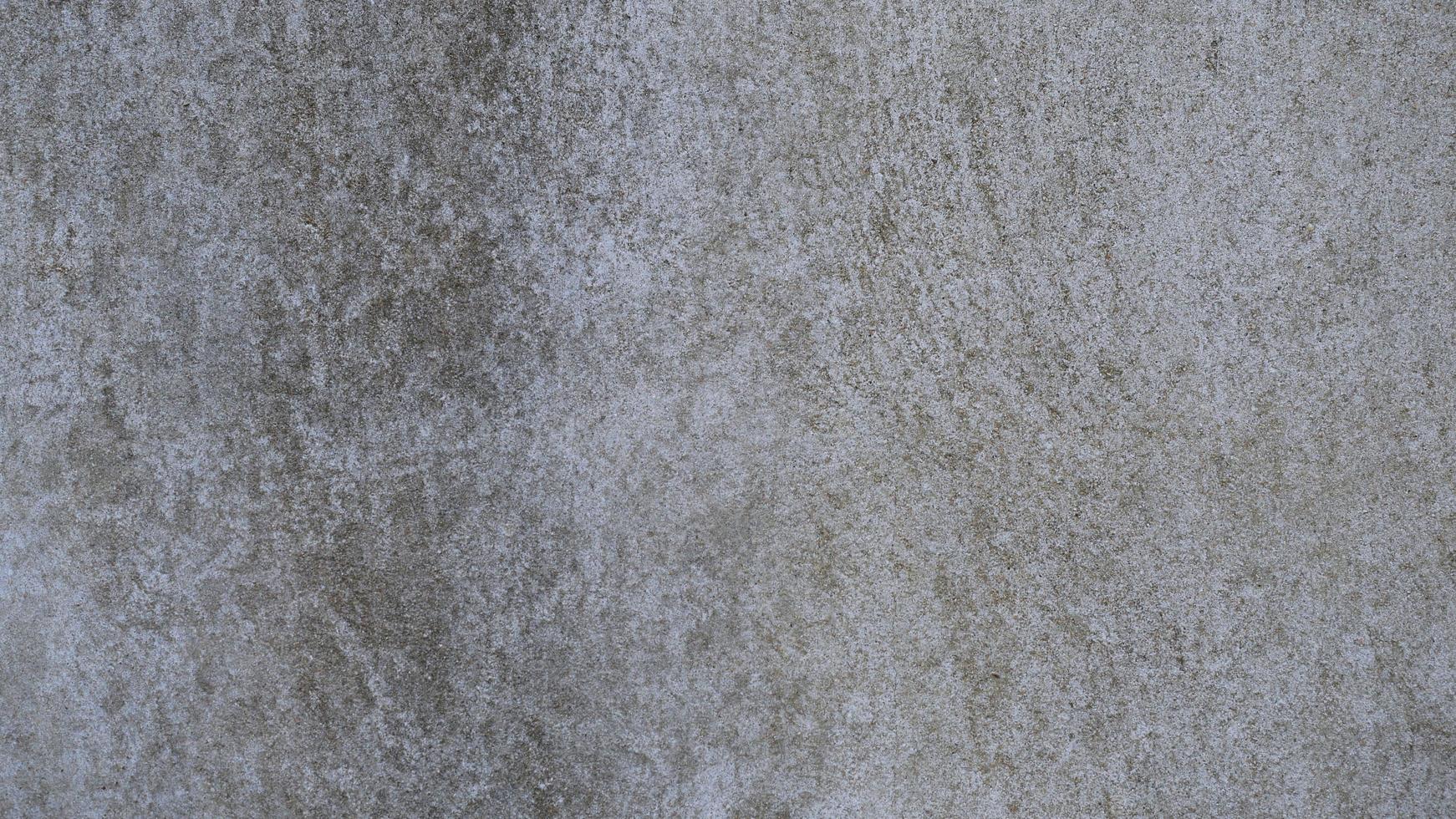 The old cement wall was weathered, the surface was scratched, the surface was scratched and damaged. For a mysterious retro-conservative background. photo