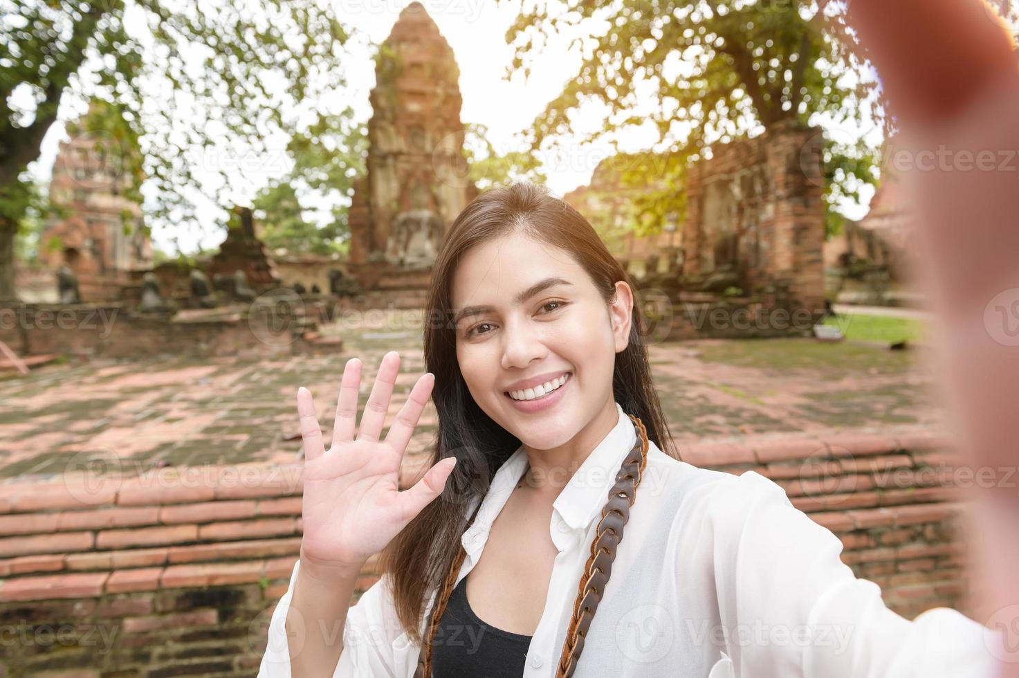 young beautiful woman traveling and taking photo at thai historical Park, Holidays and cultural tourism concept.