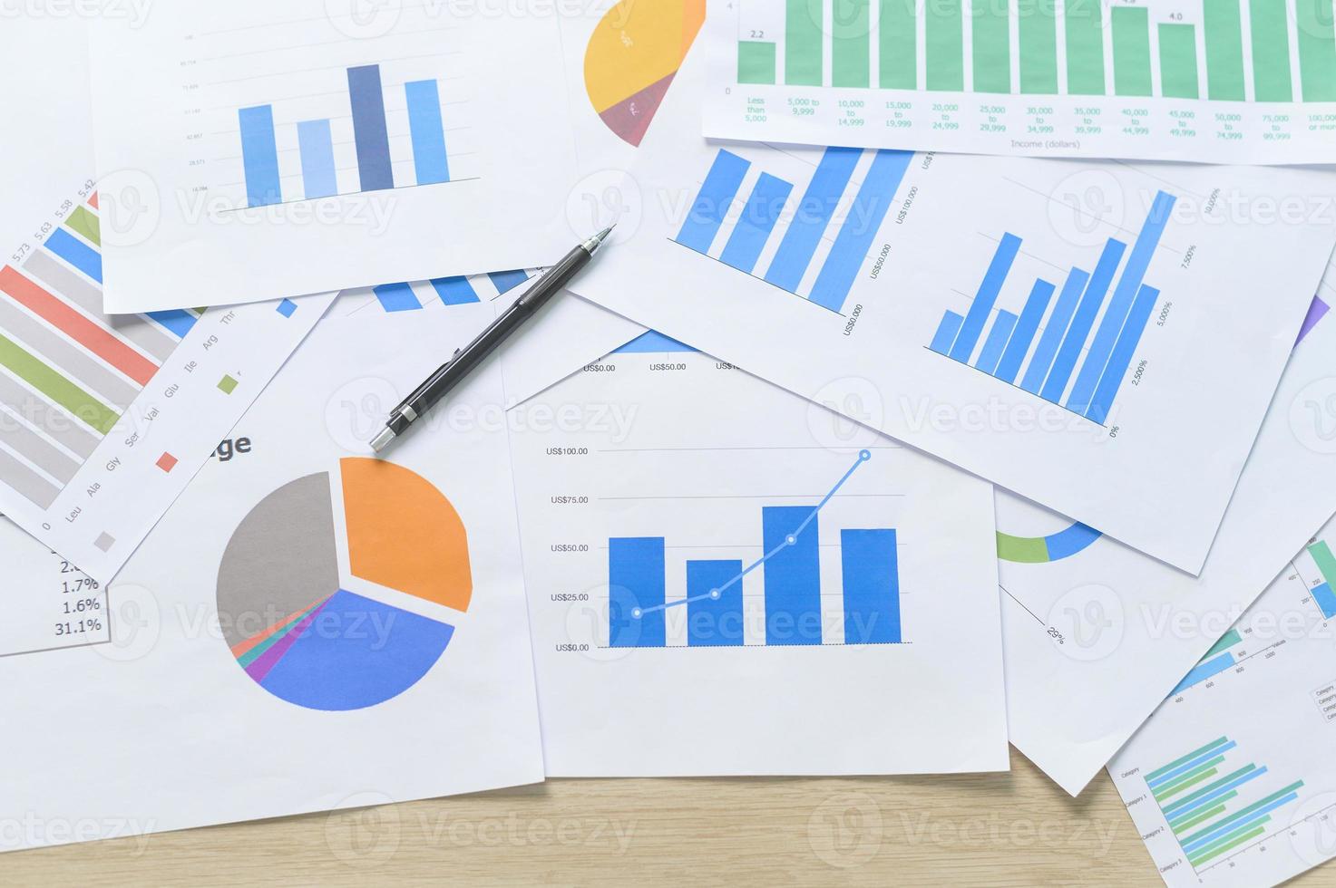 Top view of Documents with analytics data lying on table,selective focus photo