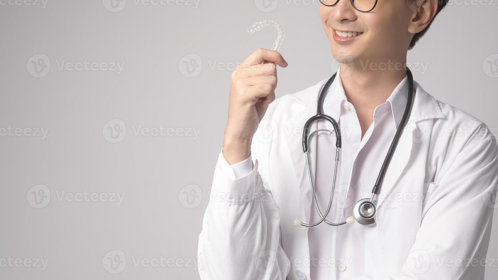 Portrait of male confident doctor over white background studio, healthcare and Medical technology concept. photo