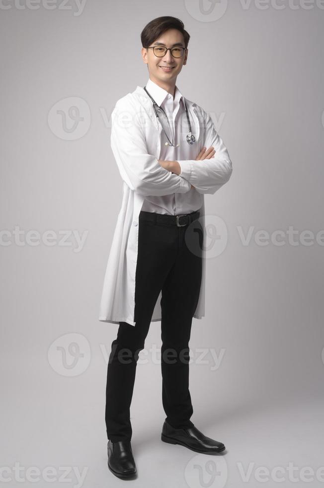 Portrait of male confident doctor over white background studio, healthcare and Medical technology concept. photo