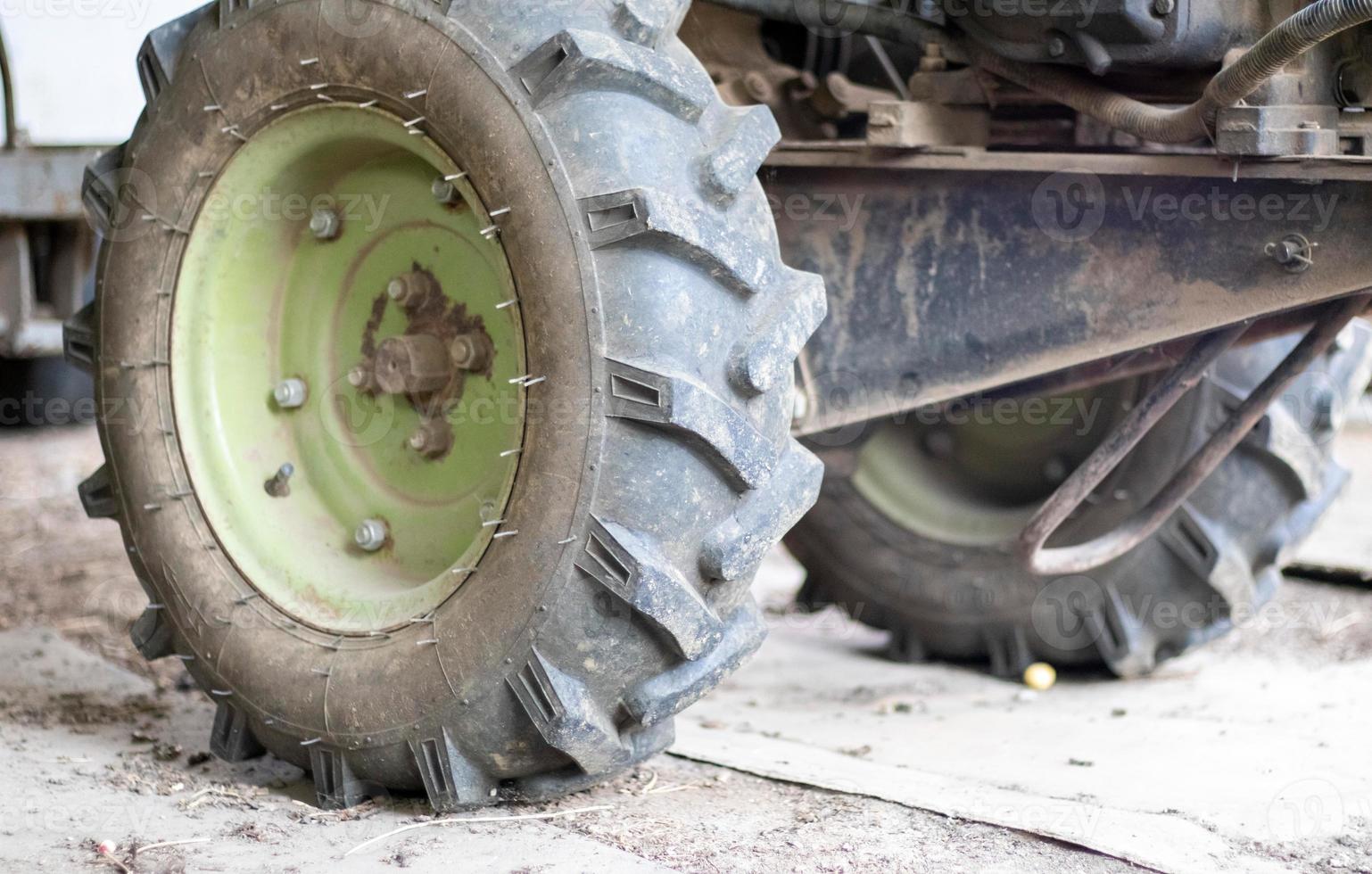 Typical heavy diesel walking tractor with trailer. Agricultural transport equipment of the countryside. Portable agricultural equipment, walking minitractor. The start system is mechanical and manual. photo