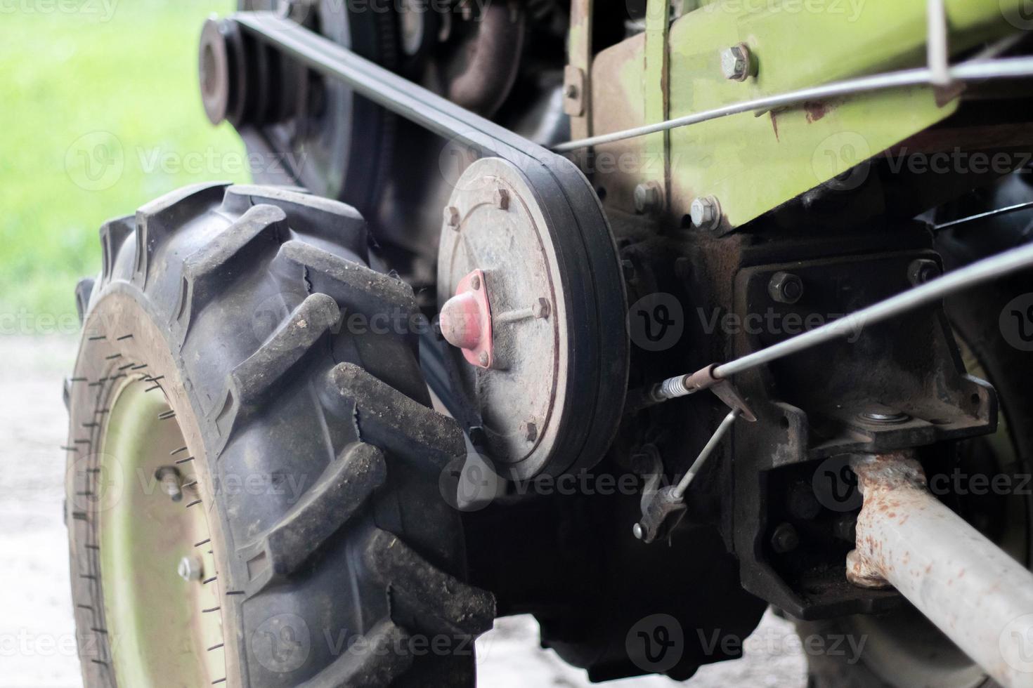 Typical heavy diesel walking tractor with trailer. Agricultural transport equipment of the countryside. Portable agricultural equipment, walking minitractor. The start system is mechanical and manual. photo