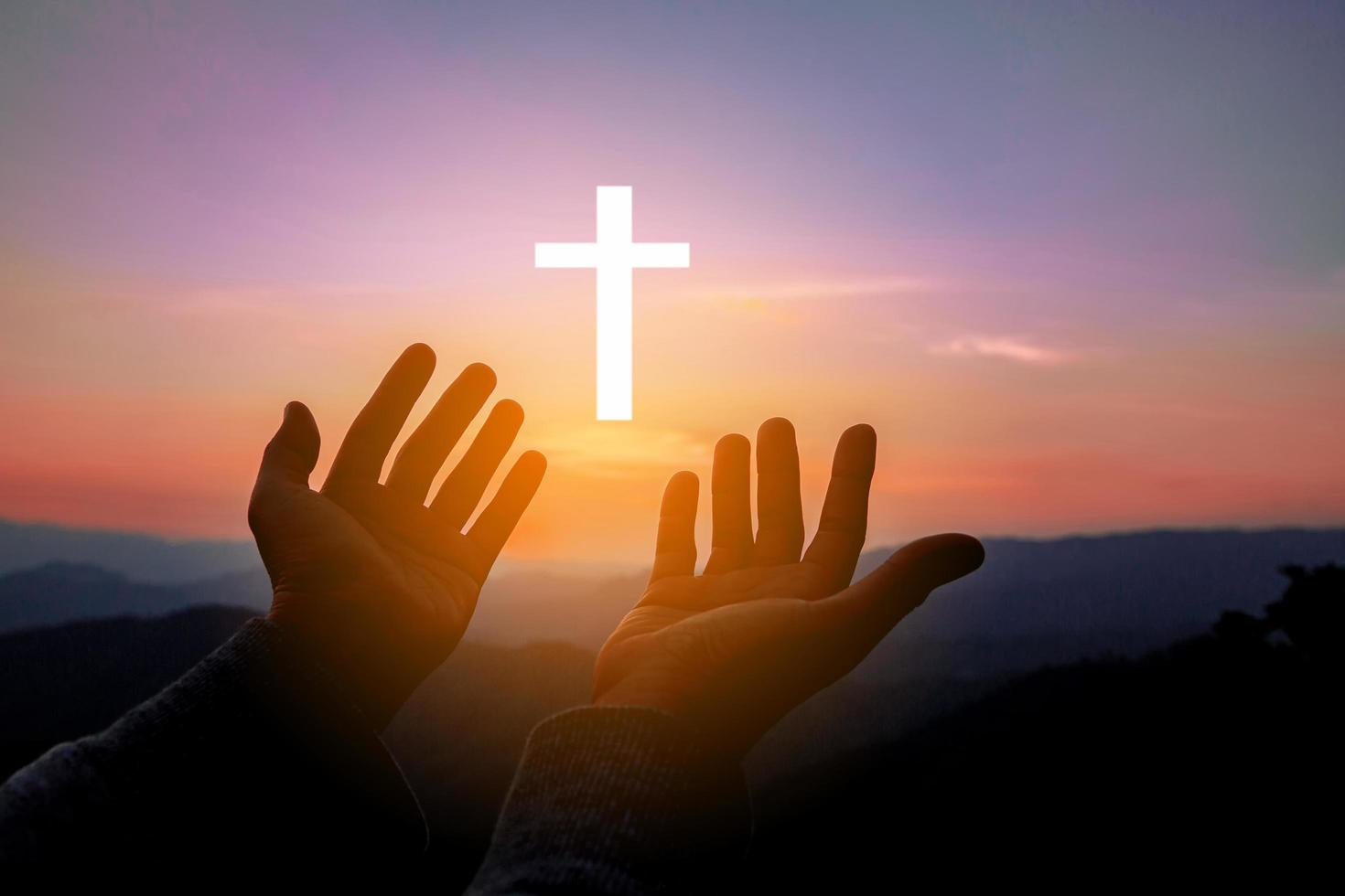 Silhouette of human hands palm up praying and worship of cross, eucharist  therapy bless god helping, belief, forgiveness, freedom, hope and faith,  christian religion concept on sunset background. 10621920 Stock Photo at