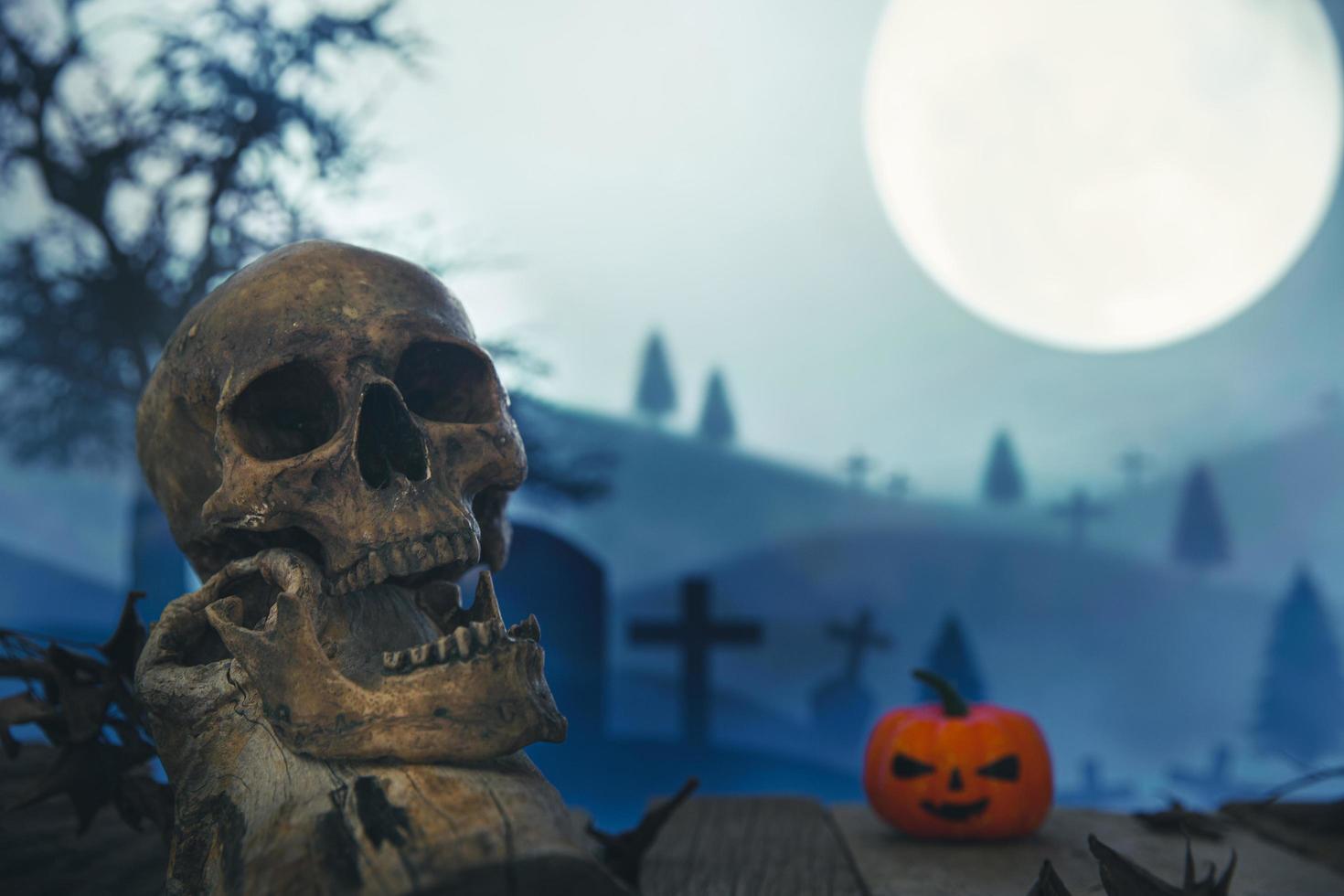 Spooky cemetery with glow halloween pumpkin photo