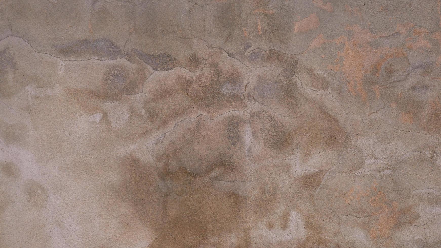 The old cement wall was weathered, the surface was scratched, the surface was scratched and damaged. For a mysterious retro-conservative background. photo