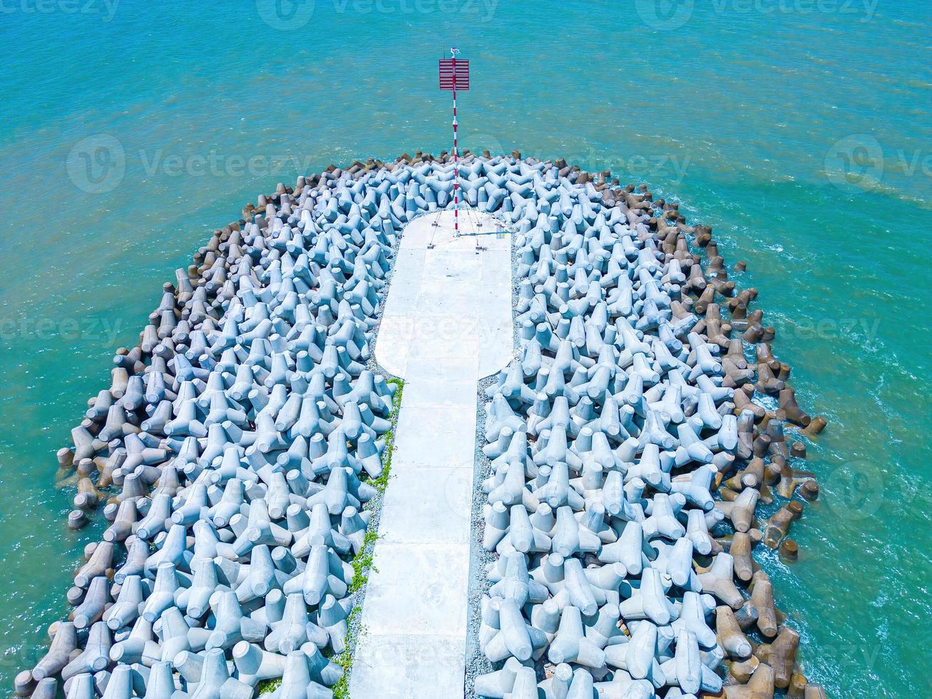 Beautiful blue skyline panoramic in Loc An Canal. Scenery landscape of fishing port with tsunami protection concrete blocks. Cityscape and boats in the sea. Loc An village near Vung Tau City. photo