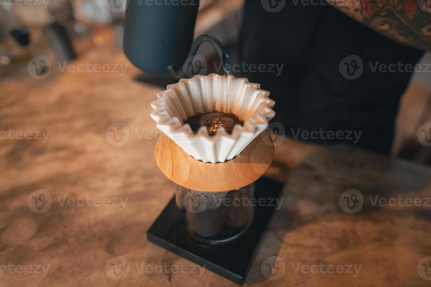Closeup of hands barista make coffee photo