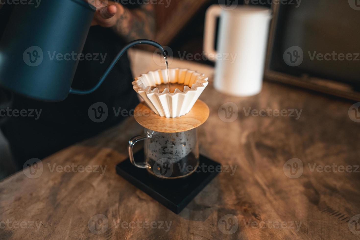 Closeup of hands barista make coffee photo