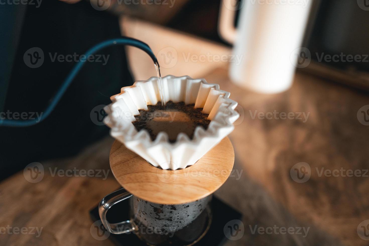 Closeup of hands barista make coffee photo