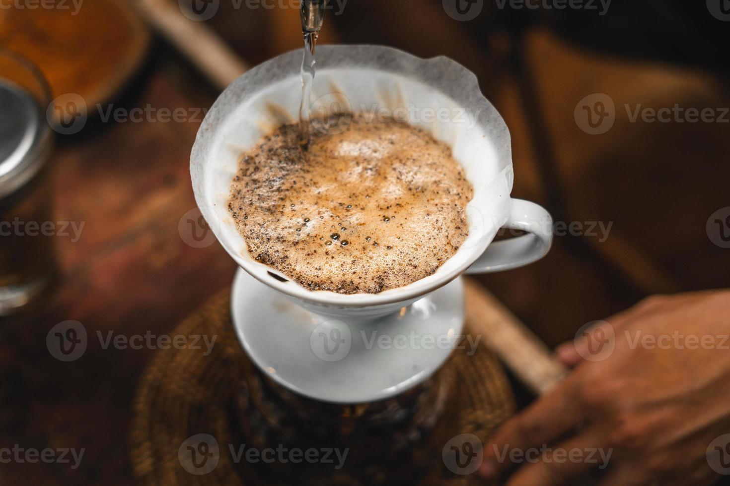 Closeup of hands barista make coffee photo