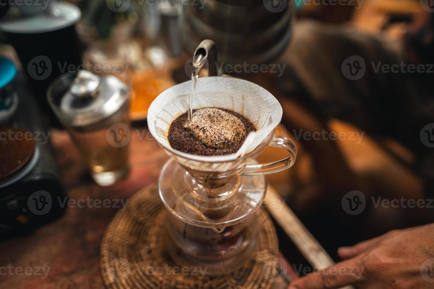 Closeup of hands barista make coffee photo