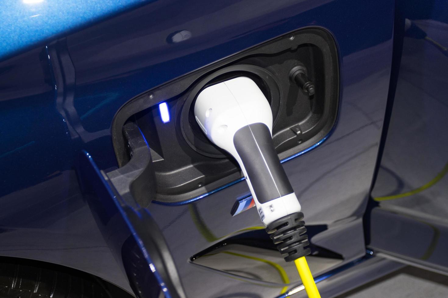 the charging the battery for the car new Automotive Innovations the power supply plugged into an electric car being charged, concept of energy innovation. photo