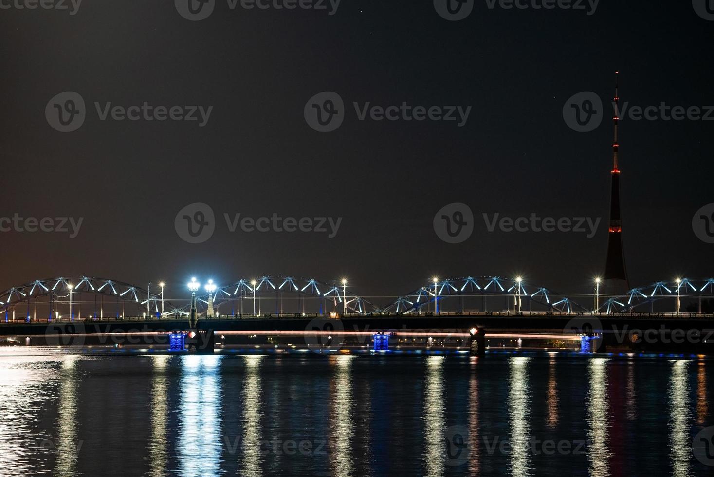 Night view of the railway bridge in Riga over river Daugava. photo