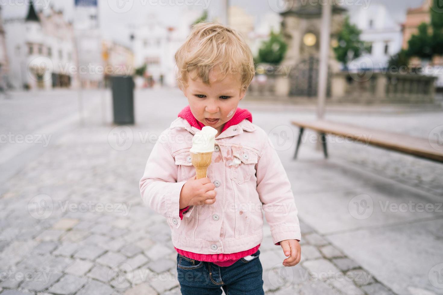 Little girl eating ice cream photo