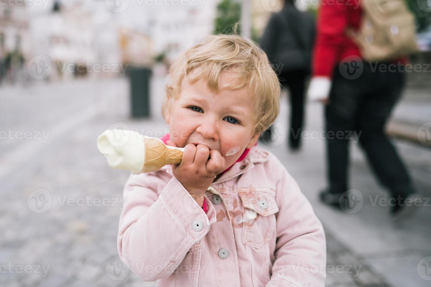 Little girl eating ice cream photo