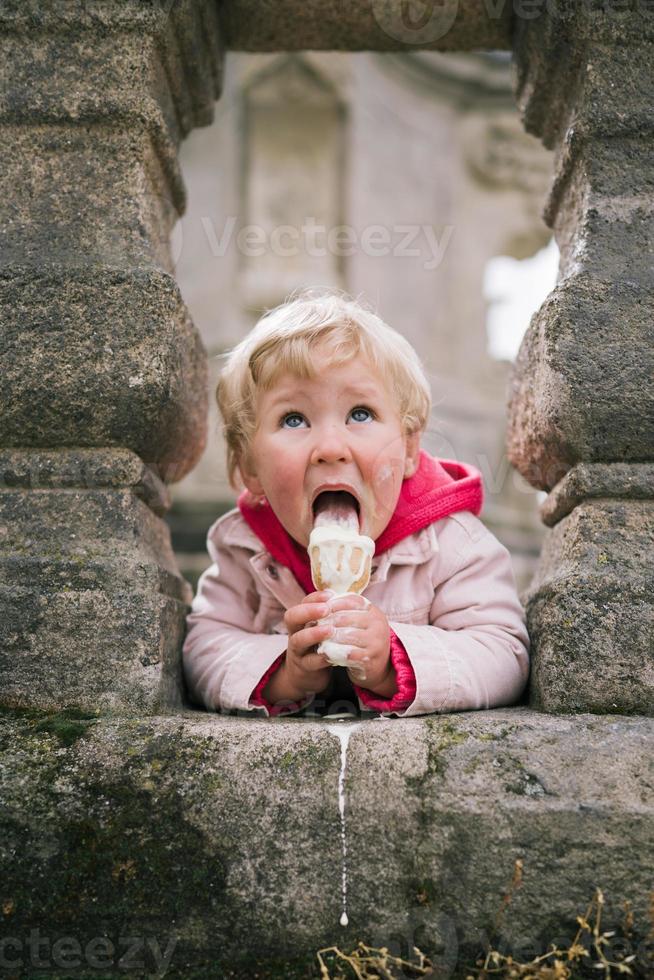 Little girl eating ice cream photo