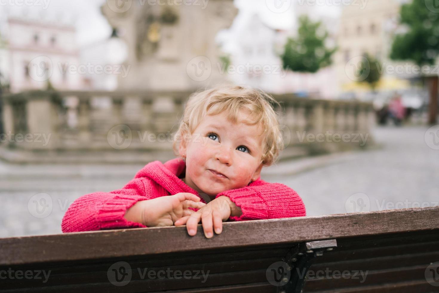 Portrait of little girl in the middle of city photo