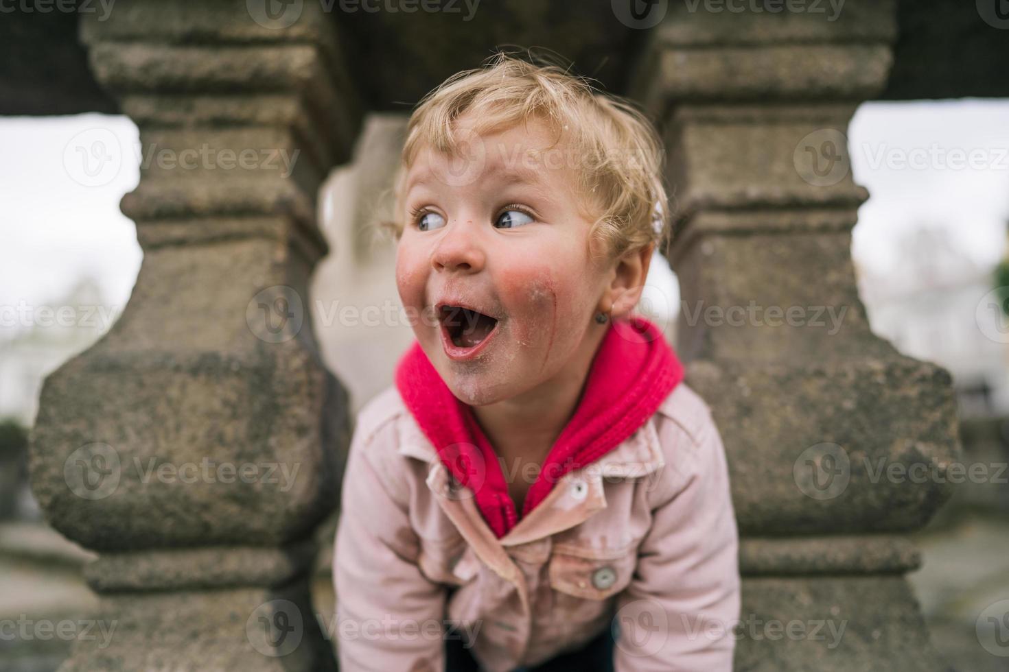 Portrait of little girl in the middle of city photo