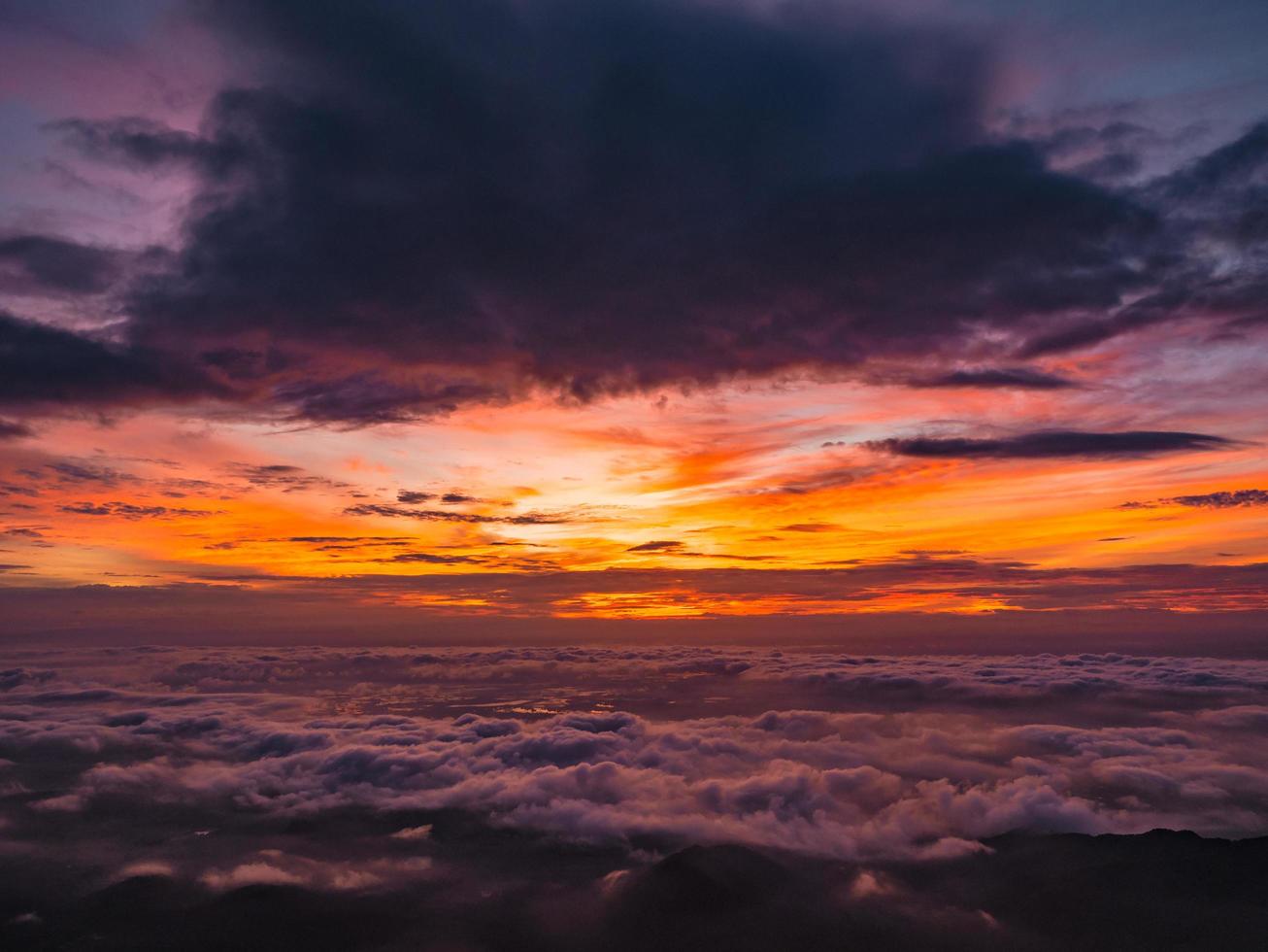 Beautiful Sunrise Sky with Sea of the mist of fog in the morning on Khao Luang mountain in Ramkhamhaeng National Park,Sukhothai province Thailand photo