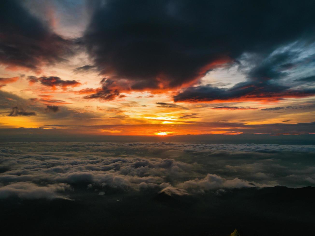 Beautiful Sunrise Sky with Sea of the mist of fog in the morning on Khao Luang mountain in Ramkhamhaeng National Park,Sukhothai province Thailand photo