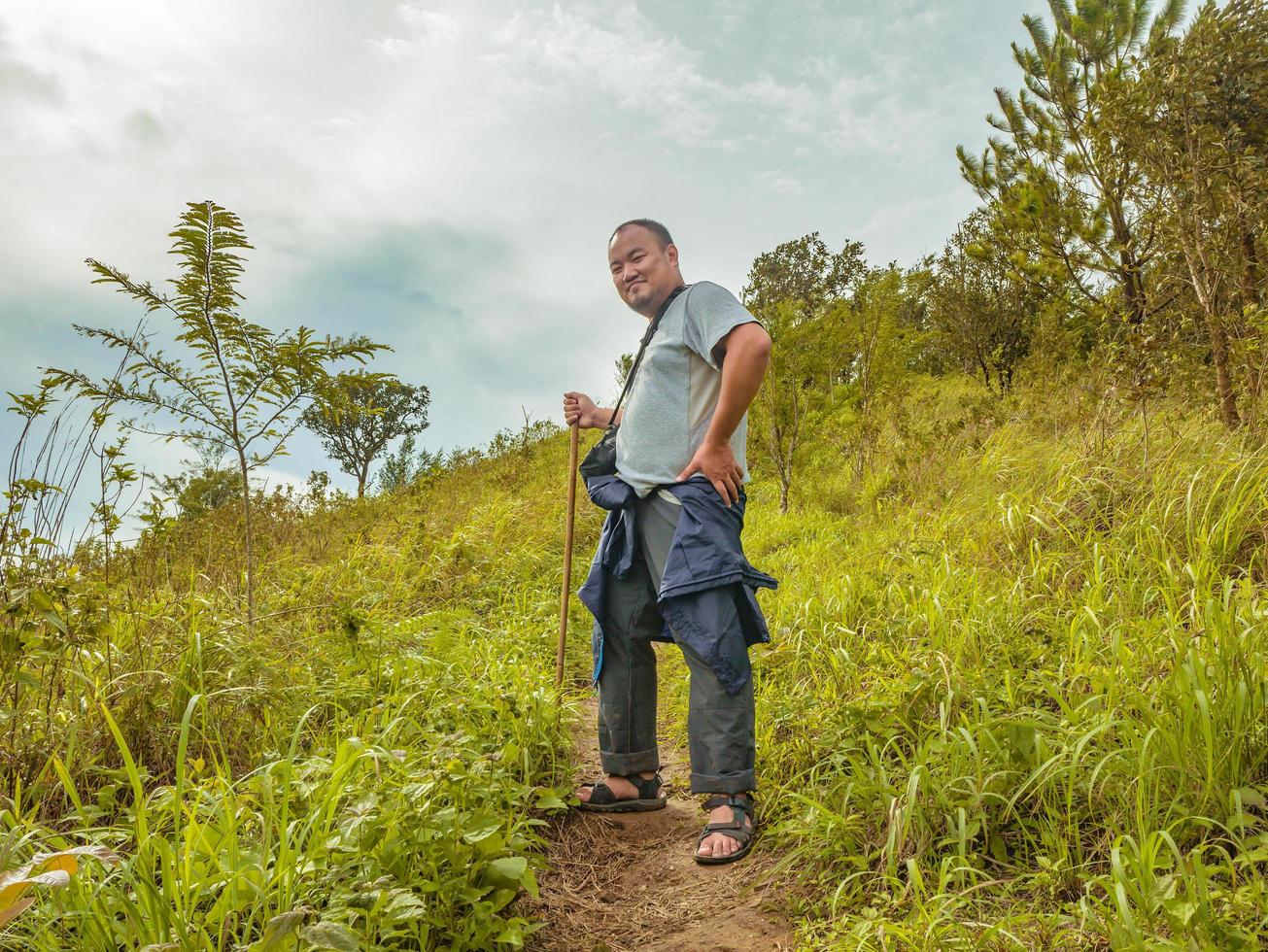 Asian Fat traveler trekking on Khao Luang mountain in Ramkhamhaeng National Park,Sukhothai province Thailand photo