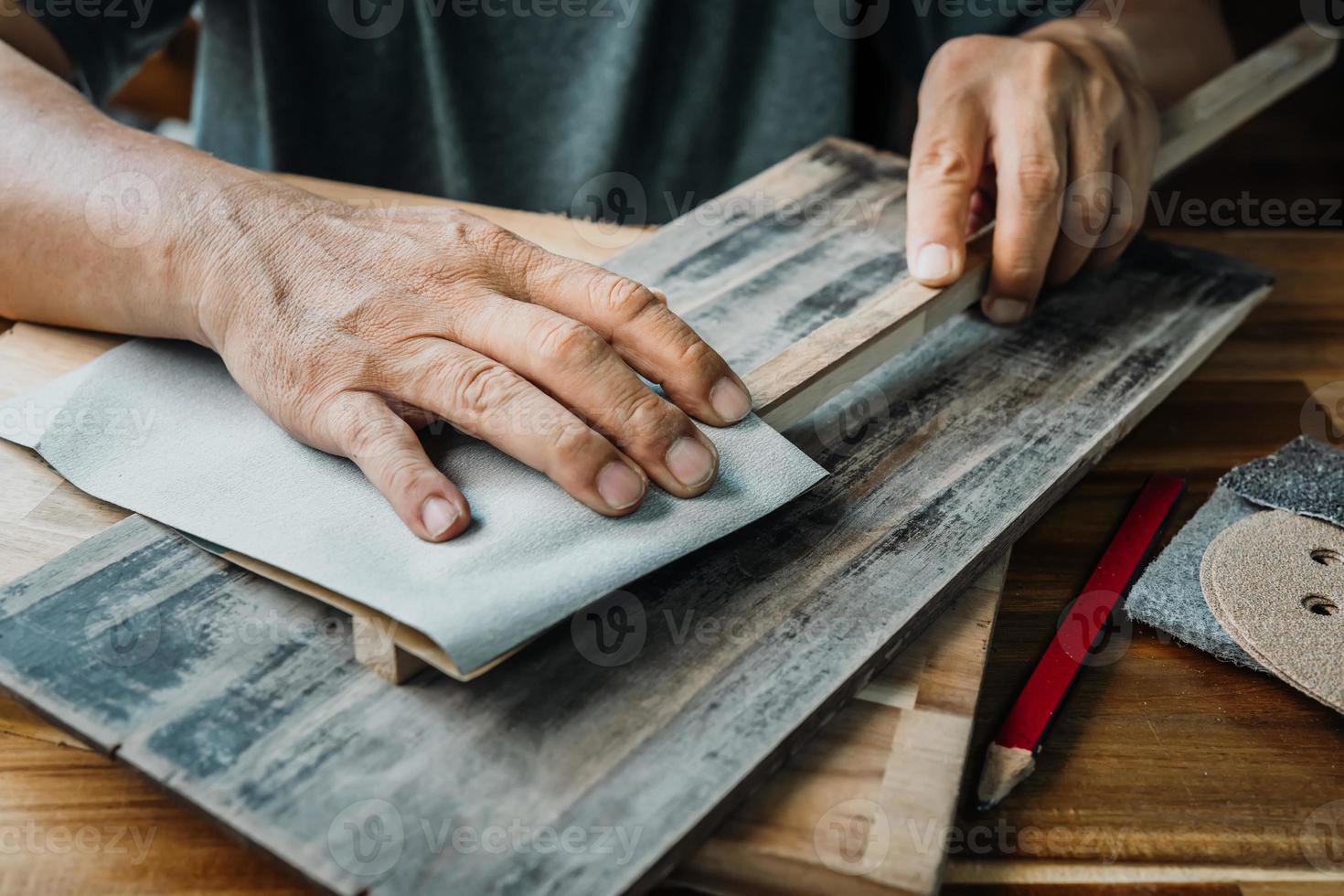 el carpintero usa papel abrasivo de lijado seco para pulir madera en el  taller, fabricante de bricolaje y concepto de carpintería. enfoque  selectivo 10640506 Foto de stock en Vecteezy