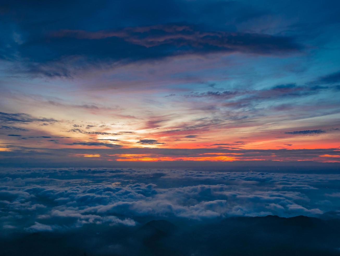 Beautiful Sunrise Sky with Sea of the mist of fog in the morning on Khao Luang mountain in Ramkhamhaeng National Park,Sukhothai province Thailand photo