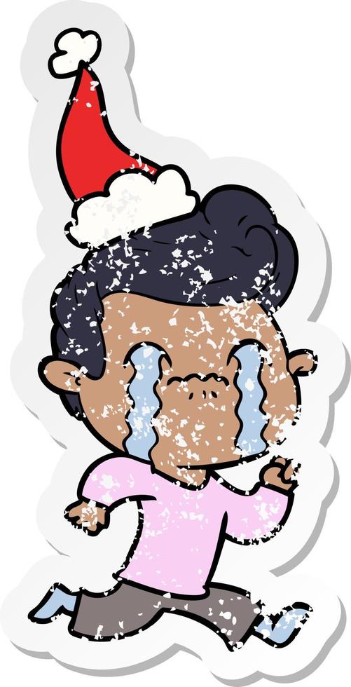 distressed sticker cartoon of a man crying wearing santa hat vector