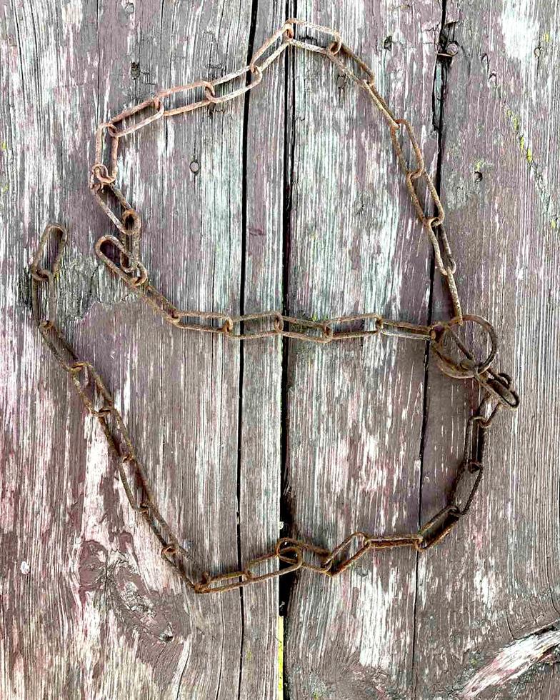 Rusty chain. Rusty chain links on a background of old wood. photo