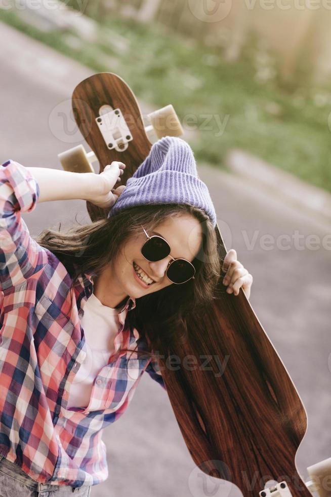 woman with longboard in the city photo