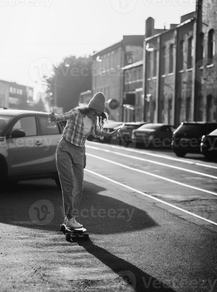 Stylish girl rides a skateboard photo