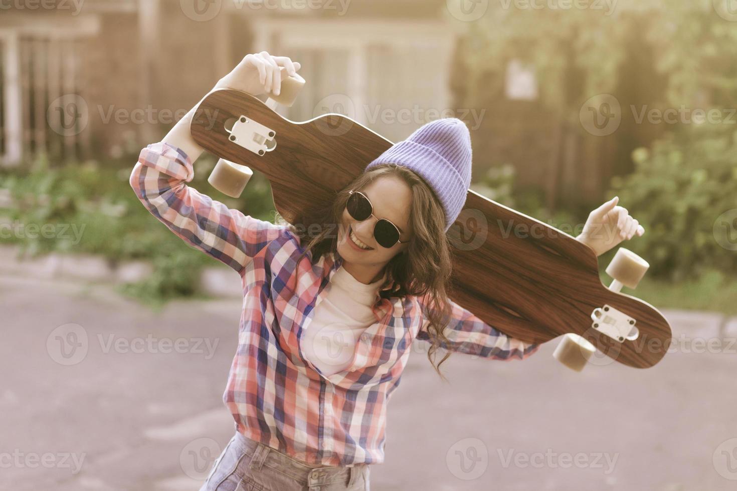 portrait happy girl with skateboard photo