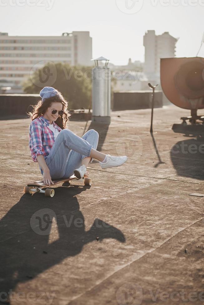 fashion woman posing on skateboard photo