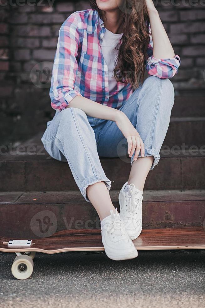 stylish young woman with skateboard photo