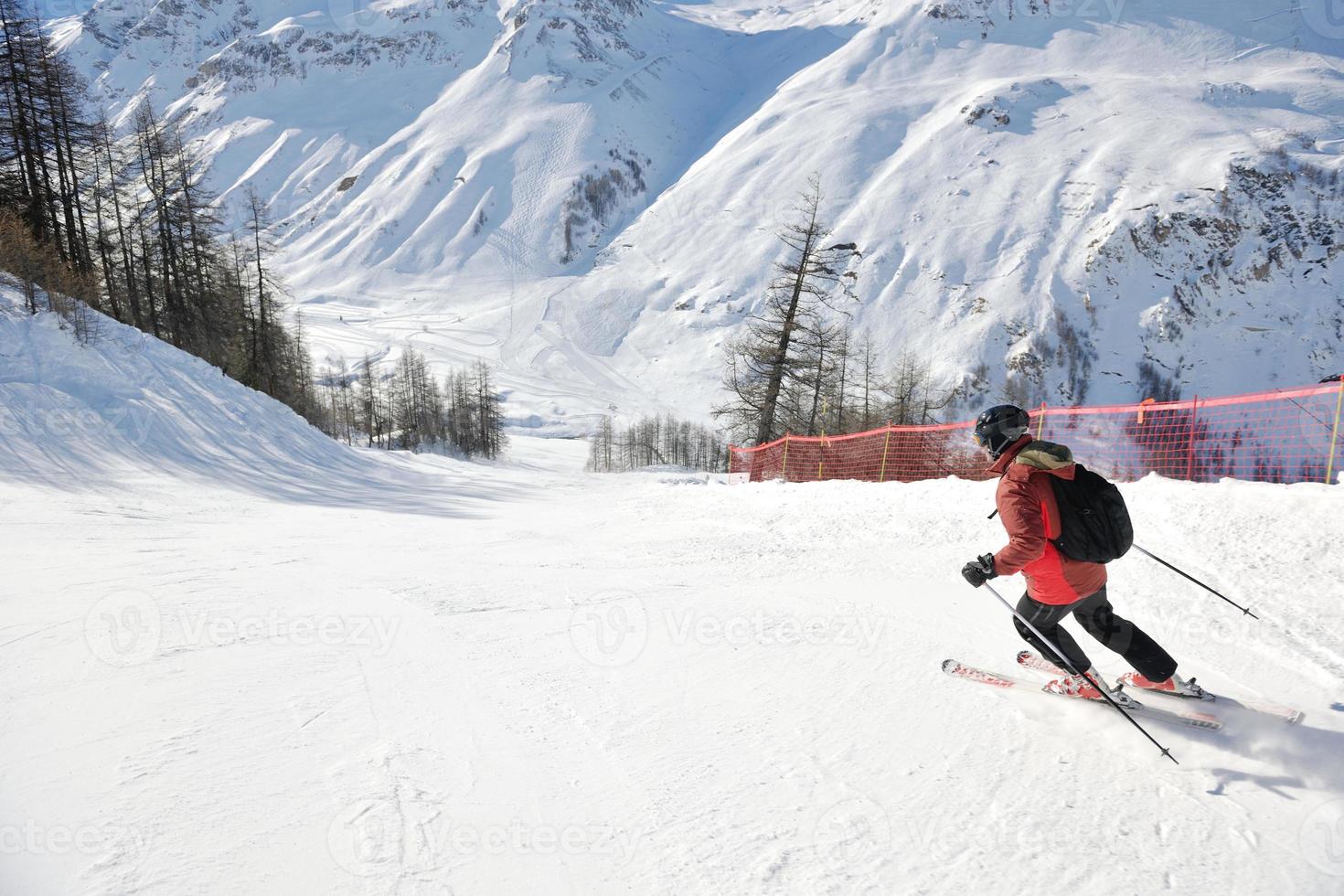 skiing on fresh snow at winter season at beautiful sunny day photo