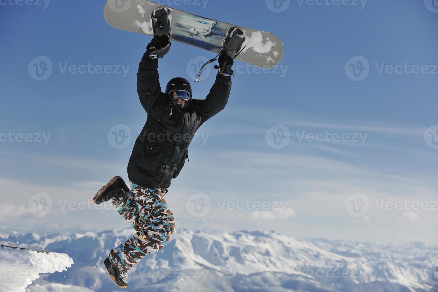 freestyle snowboarder jump and ride photo