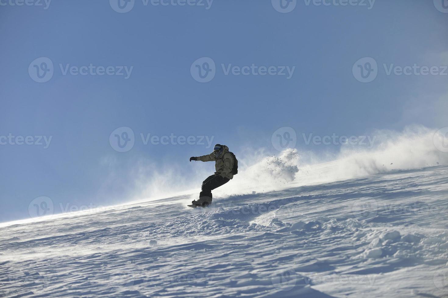 freestyle snowboarder jump and ride photo