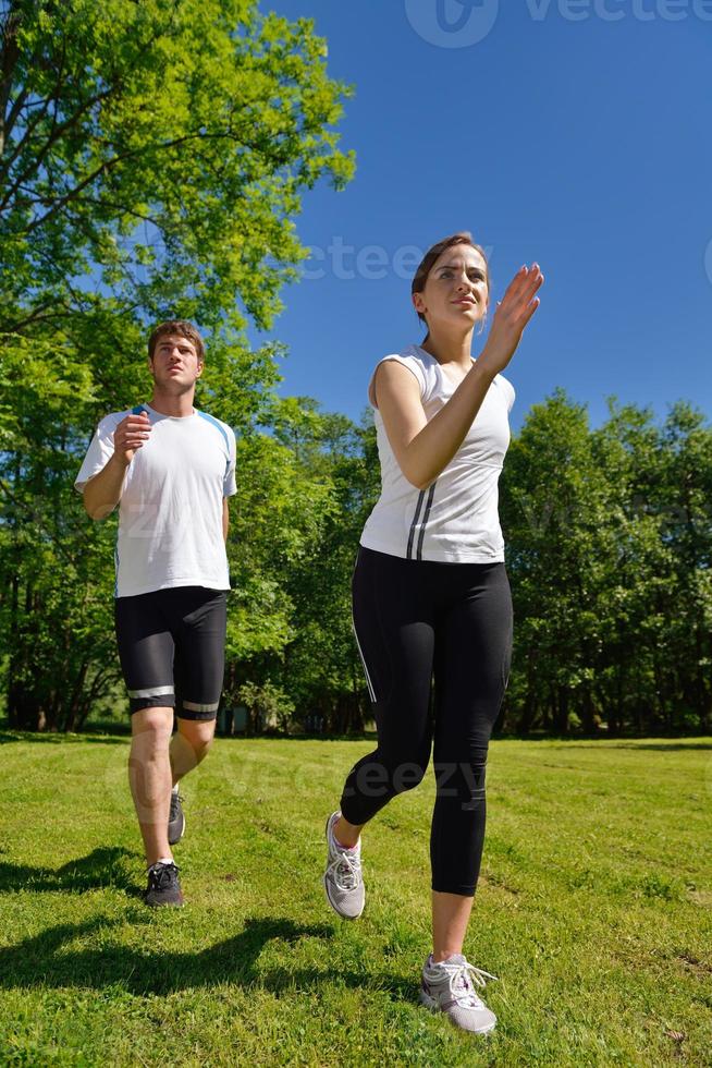 Young couple jogging at morning photo